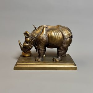 Salvador DALI (1904–1989).    ‘Rhinocéros habillé en dentelles » Bronze à patine brune et doré’. 1956.