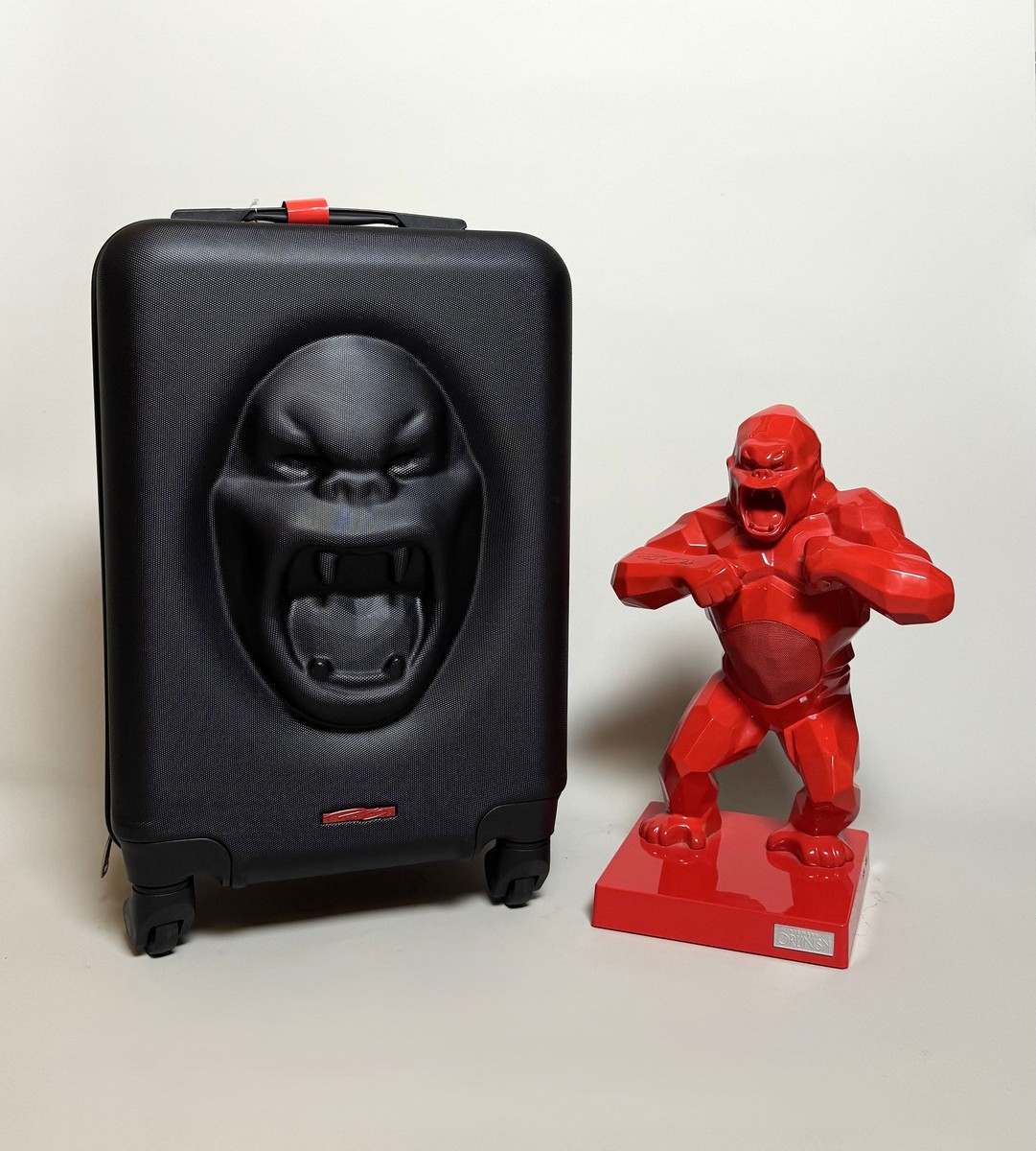 Richard ORLINSKI (Né en 1966). Kiwikong rouge métallisé et sa valise (Chrome rouge série). Enceinte décorative inspirée de la sculpture "Wild Kong". Signé « Richard Orlinski » sur le bars droit.